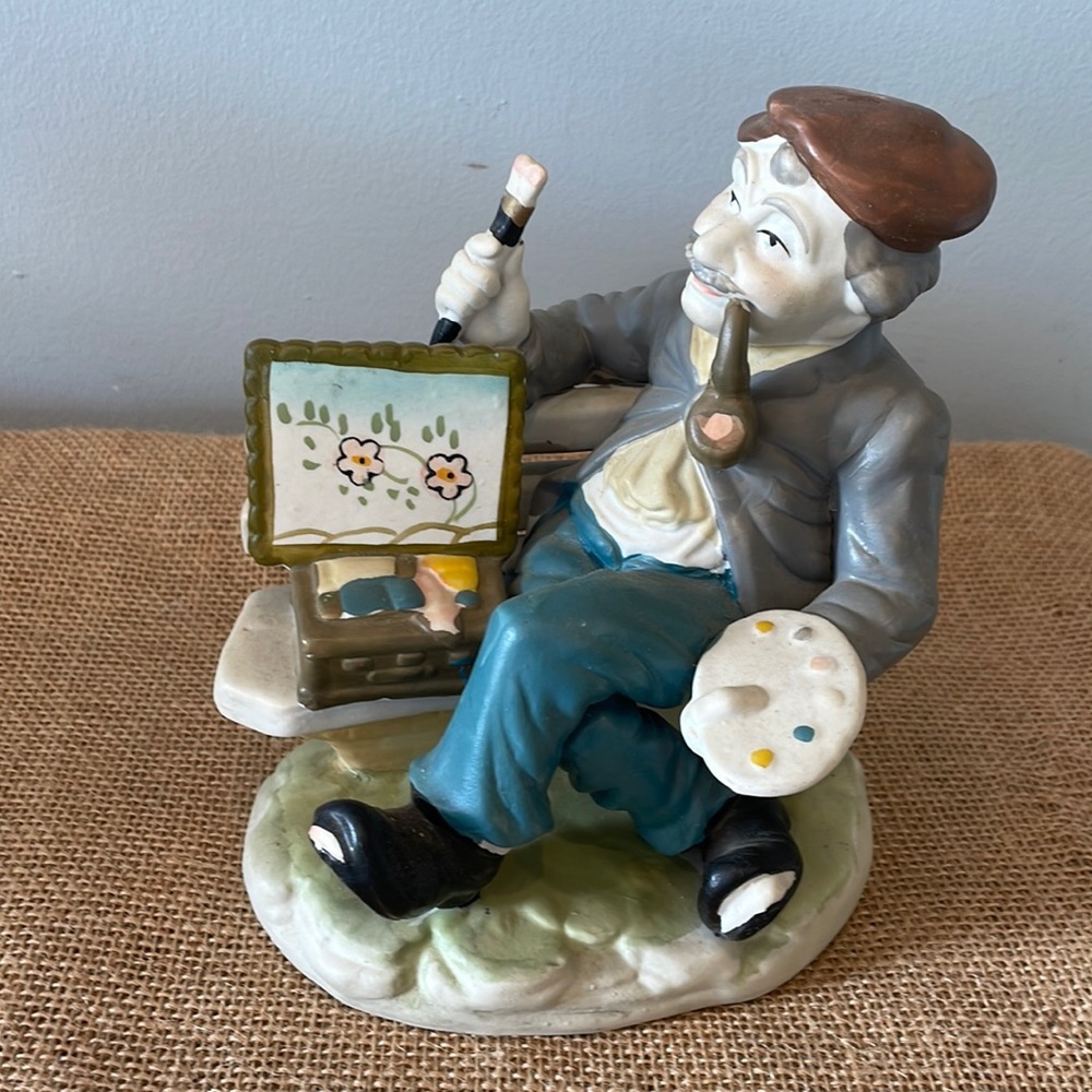 Antique ceramic painter in the park figurine